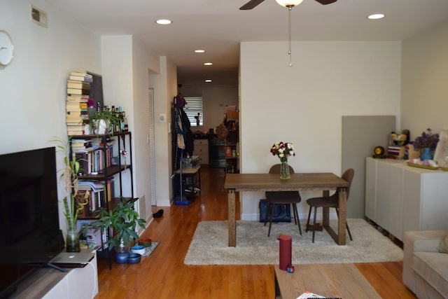 dining room with ceiling fan and wood-type flooring