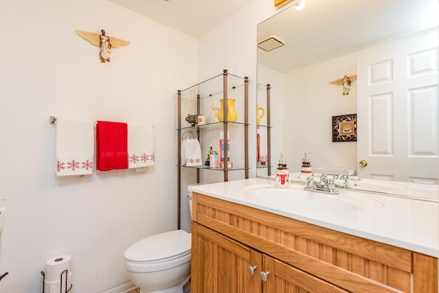 bathroom with toilet and vanity