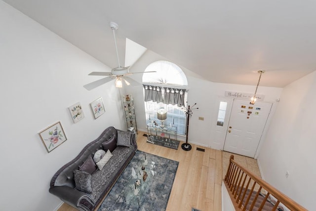 living room featuring ceiling fan and hardwood / wood-style floors