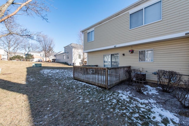 back of house featuring a deck and a yard