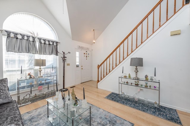 foyer featuring lofted ceiling and hardwood / wood-style floors