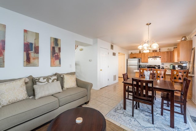 living room featuring light tile patterned flooring and a notable chandelier