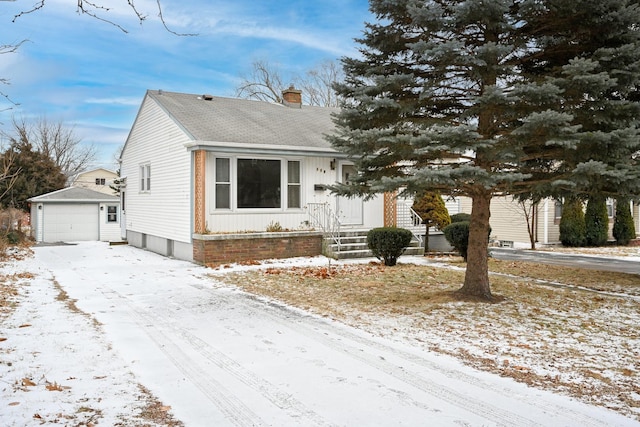 view of front of house with a garage and an outdoor structure