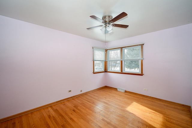 empty room with light hardwood / wood-style floors and ceiling fan