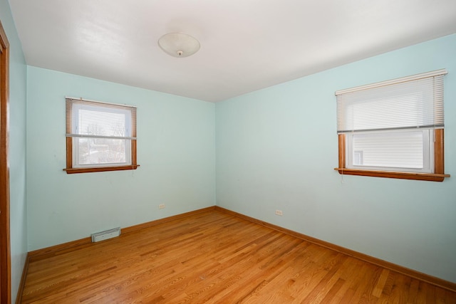 spare room featuring light hardwood / wood-style floors