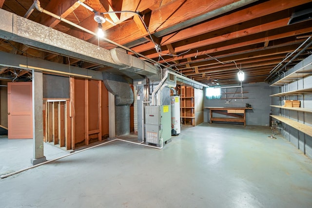 basement featuring heating unit and water heater