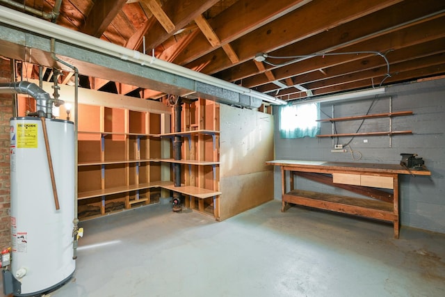 basement with a workshop area and water heater