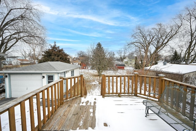 snow covered deck with a garage