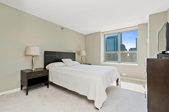 bedroom with light colored carpet