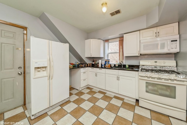 kitchen featuring sink, white cabinets, and white appliances