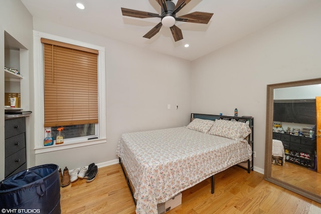 bedroom with ceiling fan and light wood-type flooring