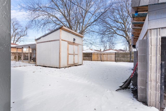 snowy yard with a shed