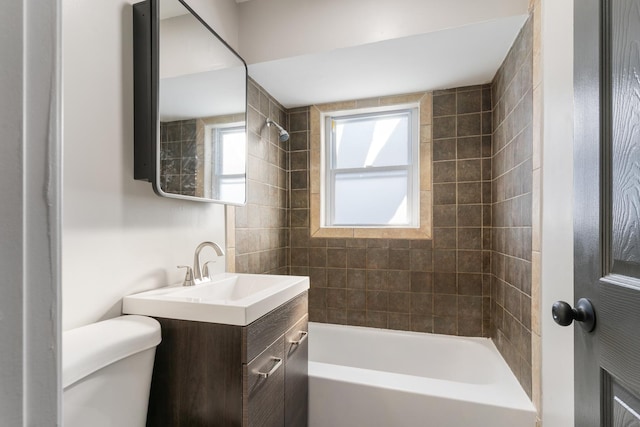 full bathroom with tiled shower / bath combo, toilet, and vanity