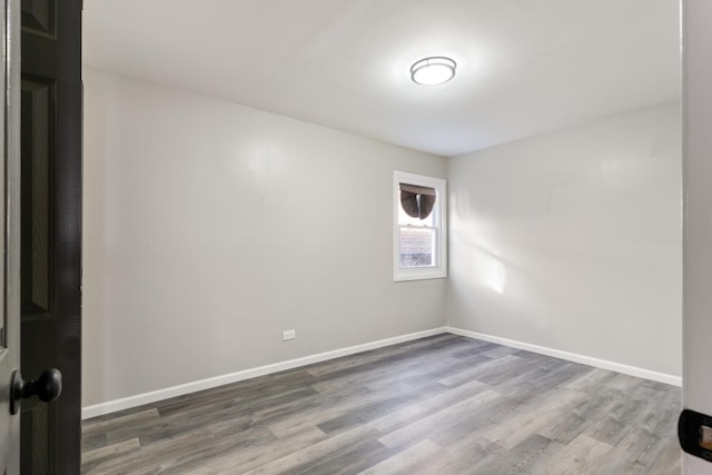 empty room with hardwood / wood-style flooring