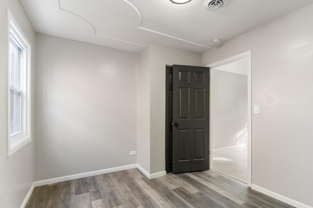 empty room with light hardwood / wood-style flooring