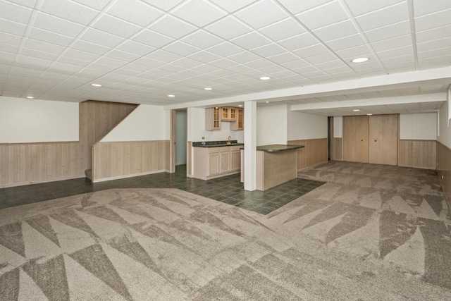 basement featuring wet bar and dark carpet