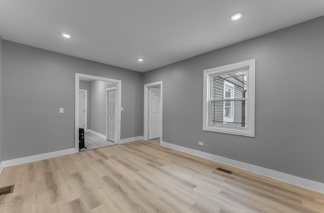 unfurnished bedroom with light wood-type flooring