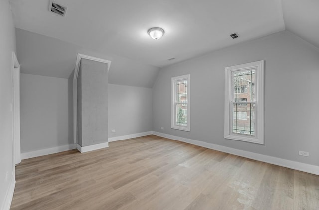 bonus room featuring vaulted ceiling and light hardwood / wood-style floors