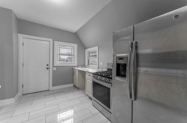 kitchen featuring vaulted ceiling and appliances with stainless steel finishes