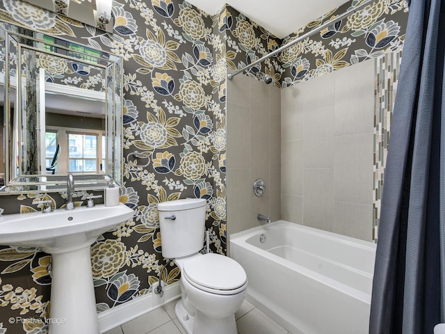 bathroom featuring toilet, tile patterned flooring, and shower / tub combo