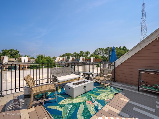 deck with an outdoor living space with a fire pit