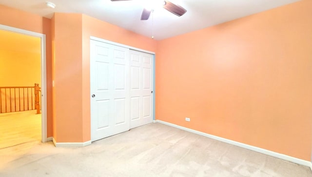 unfurnished bedroom with ceiling fan, carpet floors, and a closet