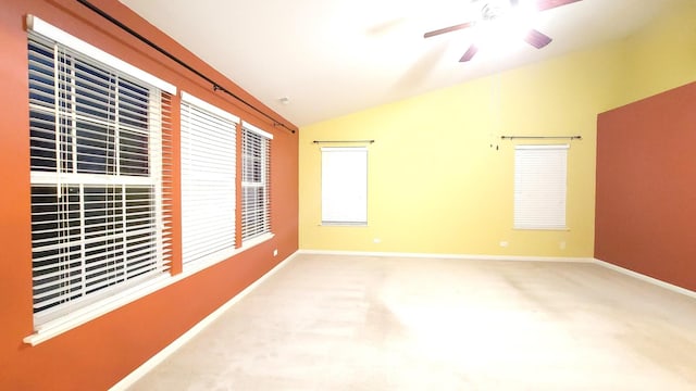 carpeted empty room with lofted ceiling and ceiling fan