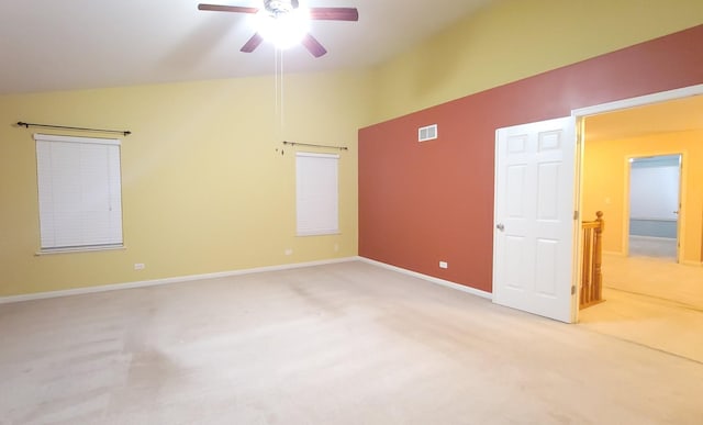 unfurnished room featuring ceiling fan, lofted ceiling, and light carpet