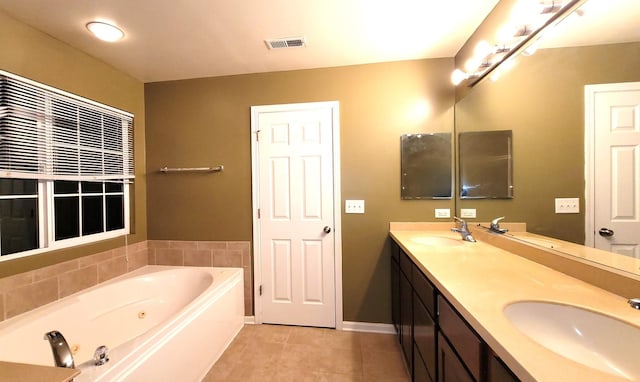 bathroom with vanity, a bathtub, and tile patterned floors