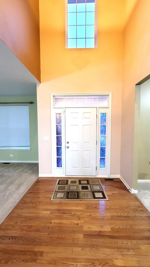 foyer featuring a high ceiling and hardwood / wood-style flooring