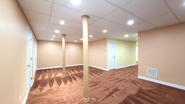 basement featuring carpet and a paneled ceiling