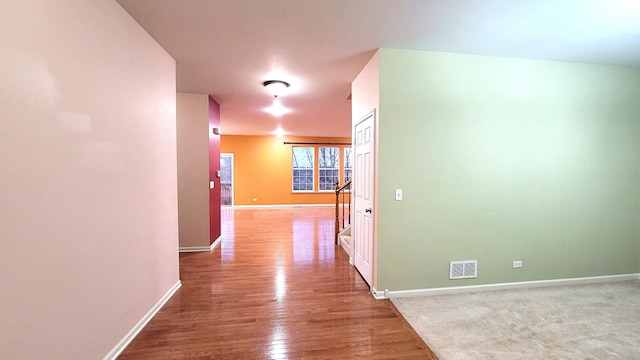 hall with hardwood / wood-style flooring