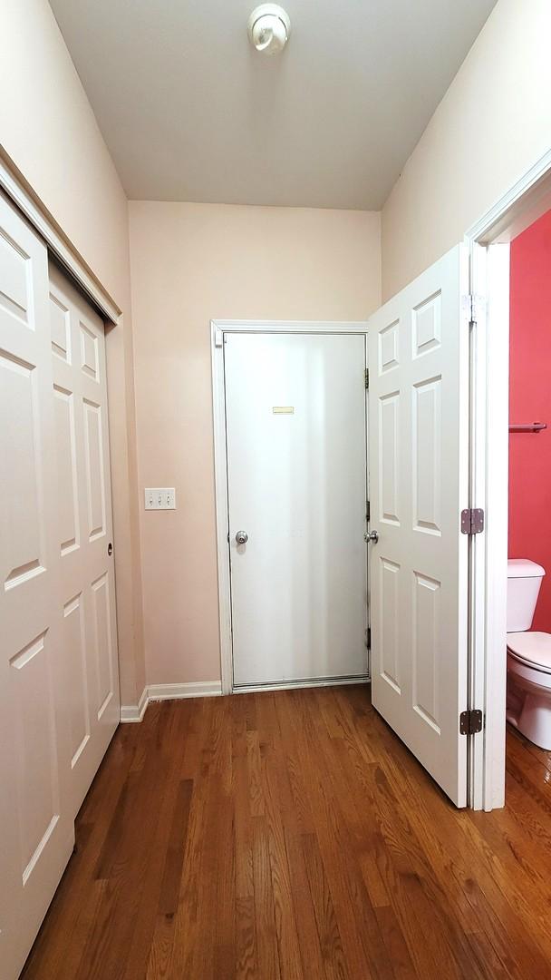 hallway with dark hardwood / wood-style floors