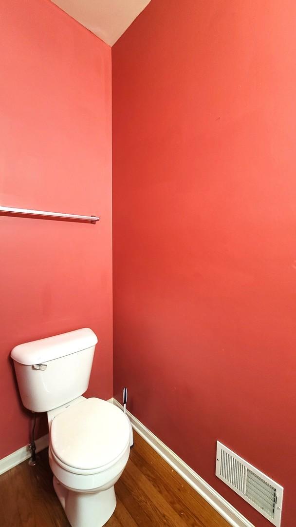 bathroom with wood-type flooring and toilet