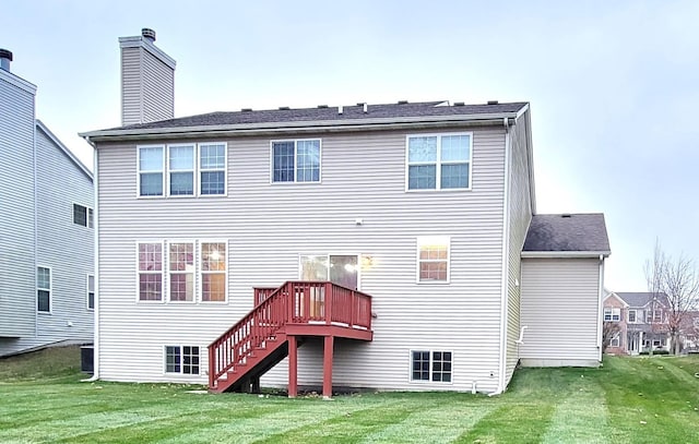 rear view of house featuring central AC unit, a lawn, and a deck