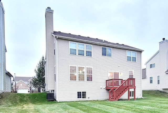 back of property with central AC, a wooden deck, and a lawn