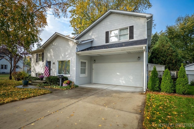 traditional home featuring an attached garage and driveway