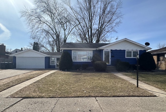 view of front facade with a garage, concrete driveway, and a front lawn