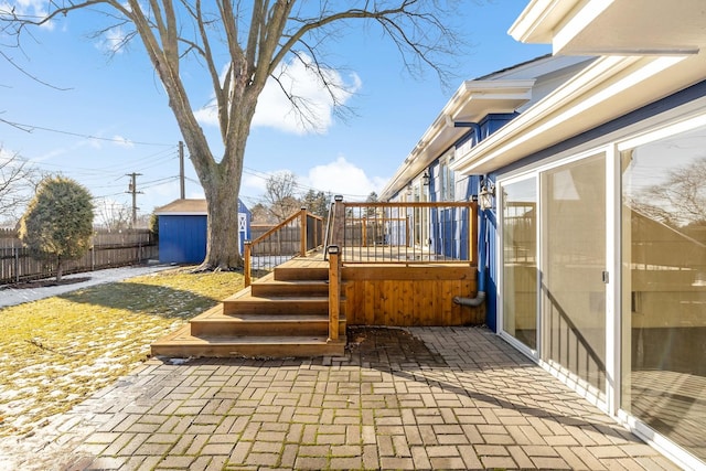 view of patio / terrace with a shed and a deck