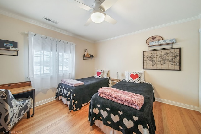 bedroom with crown molding, ceiling fan, and light hardwood / wood-style floors