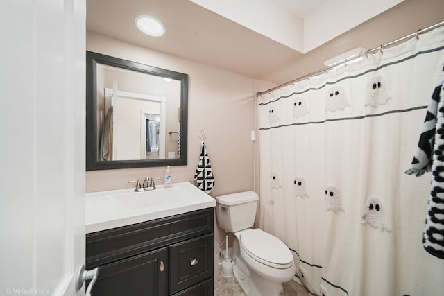 bathroom featuring vanity and toilet