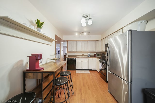 kitchen featuring electric stove, sink, stainless steel fridge, dishwasher, and ornate columns