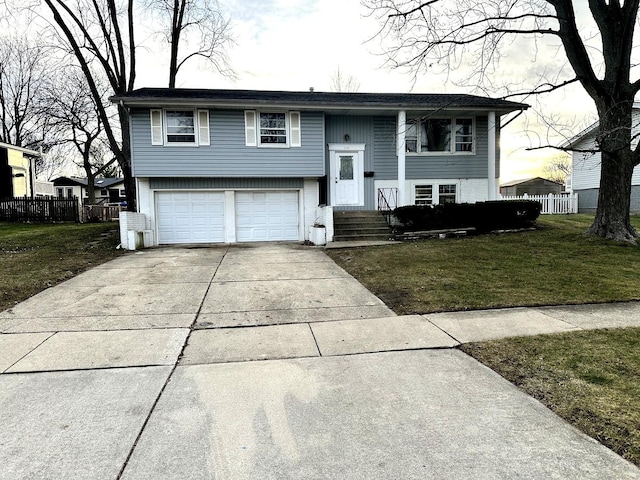 split foyer home with a yard and a garage