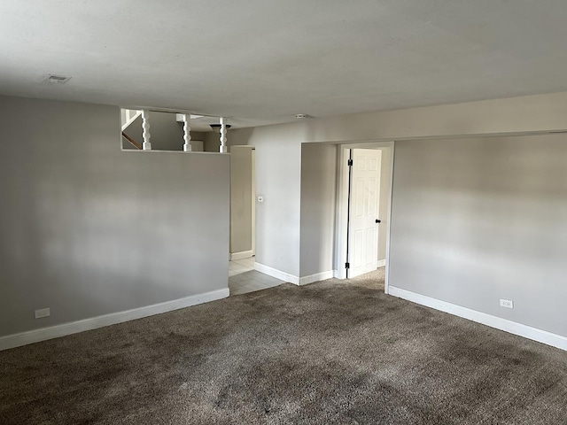 unfurnished room featuring light carpet