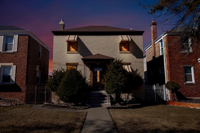 view of front of house featuring brick siding and a chimney