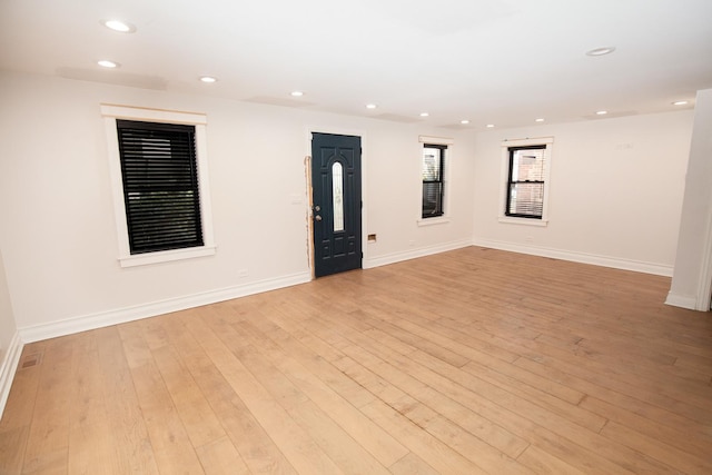 unfurnished room with recessed lighting, light wood-style flooring, and baseboards