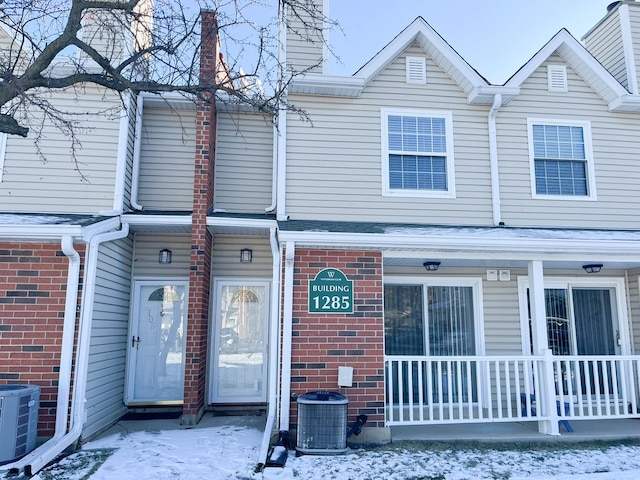 view of front of property featuring covered porch and cooling unit