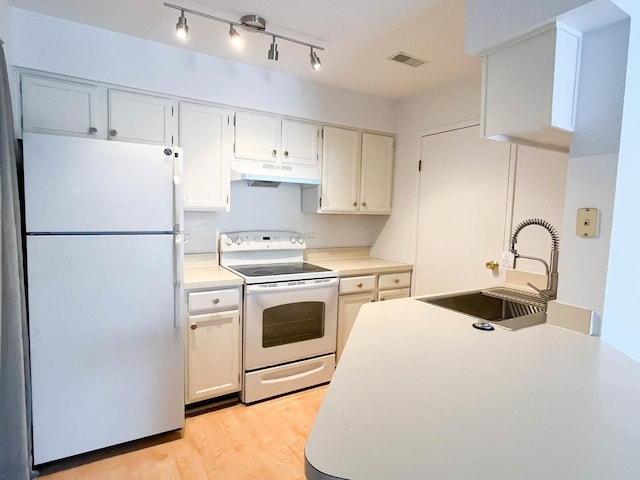 kitchen featuring sink, light hardwood / wood-style floors, white cabinets, and white appliances