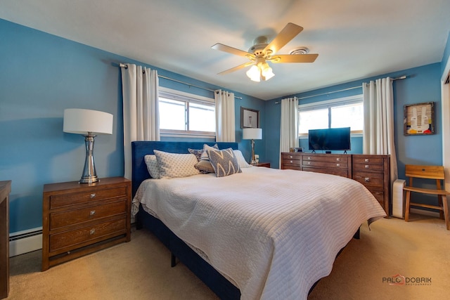 carpeted bedroom with a baseboard radiator and ceiling fan