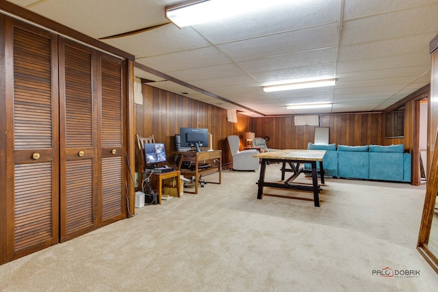 living room featuring a paneled ceiling and carpet floors